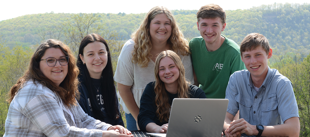 Students sitting around table