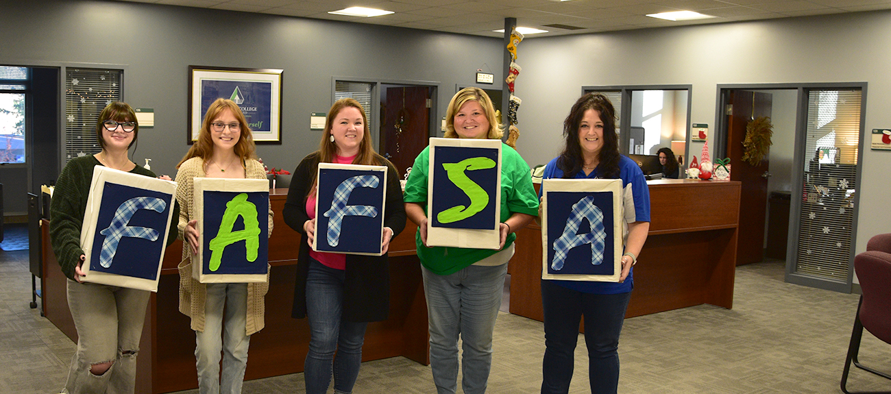 Students and Staff holding FAFSA boxes