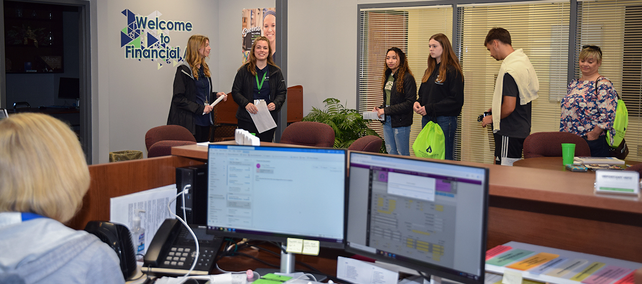 Students taking a tour through the Financial Aid Office