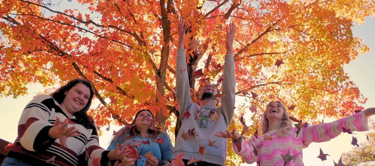 Students throwing leaves