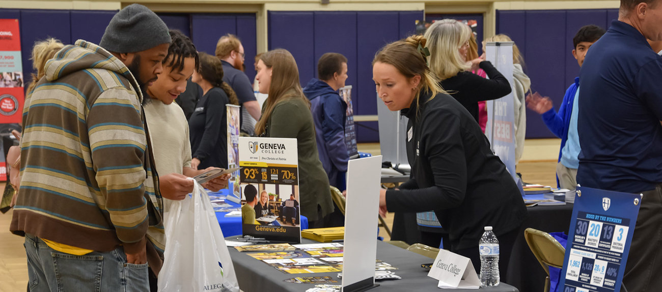 indivduals looking at a college table