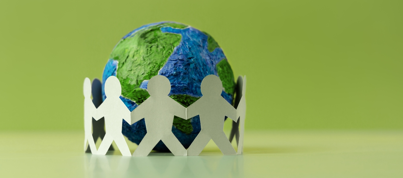 Earth Day Cutout of people standing around the globe